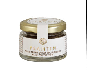 Photo d'un pot de truffe, présenté sur un fond blanc.